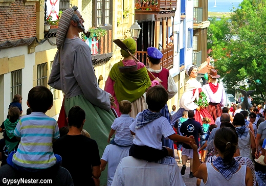 Gigantes y cabezudos march and dance through Hondarribia, Spain
