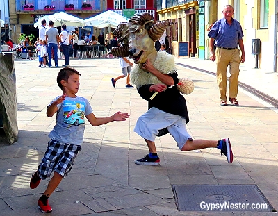 A cabezudo chases a child in Hondarribia, Spain
