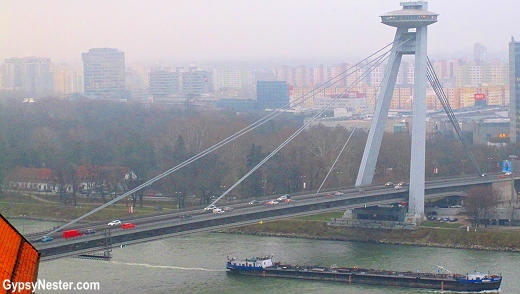 The New Bridge (Nový most) and its flying saucer-shaped restaurant called UFO disappearing in the mist in Bratislava, Slovakia