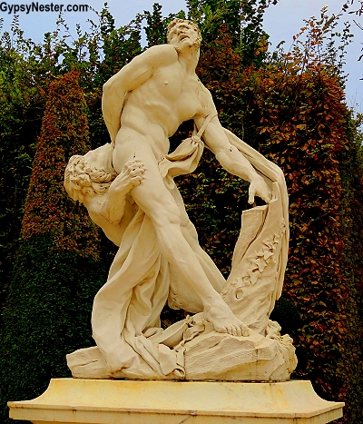 Statue of man and lion in the gardens of the Palace of Versailles near Paris, France