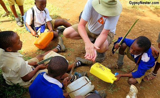 David and his students play makeshift drums during recess in Tanzania. GypsyNester.com