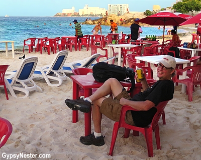 David enjoying a cerveza at Playa Tortugas beach in Cancun, Mexico, GypsyNester.com