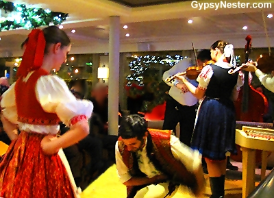 Slovak musicians and dancers come aboard to entertain. Dulcimer, violins, and double bass accompany singers and dancers with traditional folk songs