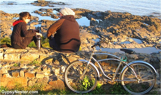 A couple enjoys yerba mate on the beach in Colonia Uruguay