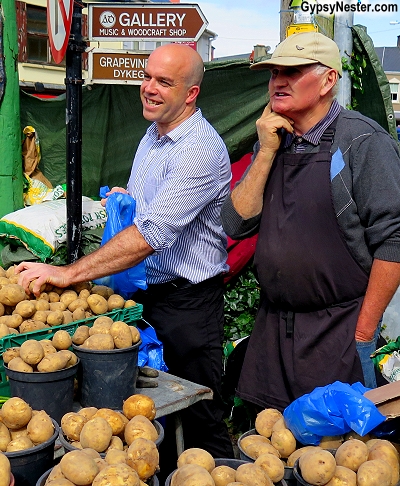 Choosing potatoes at the open air market in Dingle, Ireland