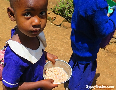 Children eat at the primary school in Rau, Tanzania. The food is provided by a good samaritan