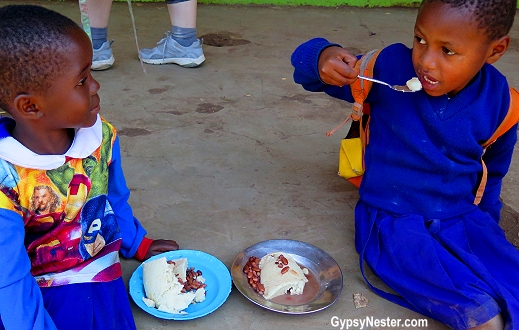 Children eat at the primary school in Rau, Tanzania. The food is provided by a good samaritan