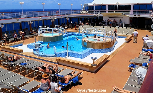 Passengers aboard Fathom's Adonia catch some pool time between Impact Workshops