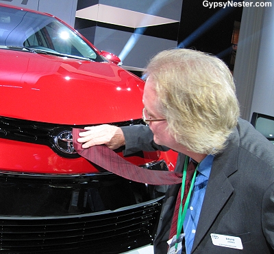 David uses his tie to polish the logo on the newly unveiled The 2014 Toyota Corolla