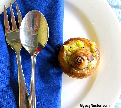 A lightly cooked, nutricious snail in a mushroom at Glasshouse Gourmet Snails in the Hinterlands of Queensland, Australia