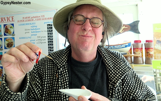 David eats herring in Hoorn, Holland GypsyNester.com