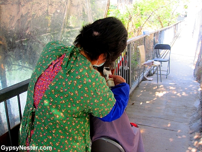 A sidewalk hair cutting session near Aberdeen Harbor in Hong Kong