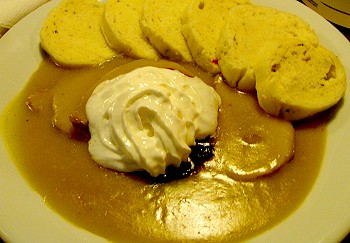 Svičková, roast meat, pork in this case, with sweet gravy, whipped cream, cranberry sauce and sliced dumplings