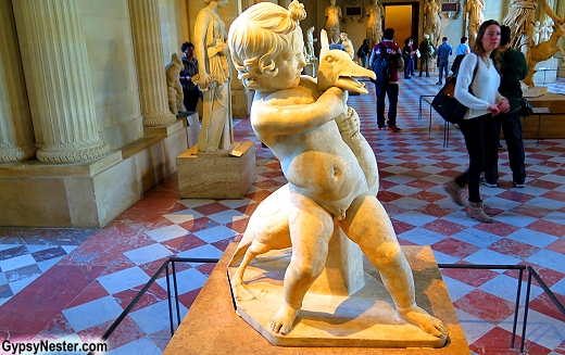 Boy wrestling goose at the Louvre in Paris