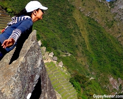 Veronica hangs over a cliff at Machu Picchu! GypsyNester.com