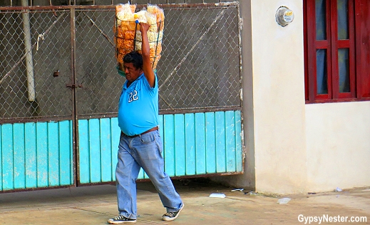 Carrying wares on the street in Piste, Mexico