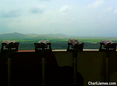 Looking through binoculars at the DMZ in Korea