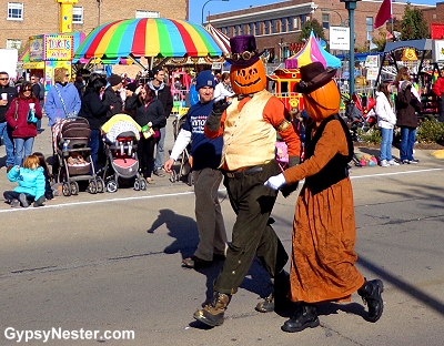 People with pumpkins on their heads at the Sycamore Pumpkin Fest in Illinois