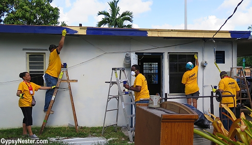 Rebuilding Together volunteers paint a retired nurses home. It had fallen into disrepair