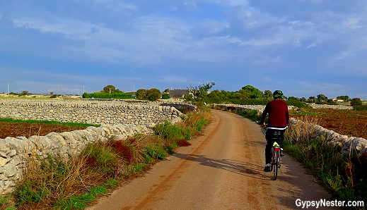 Biking while surrounded by the stone walls in the Sicilian countryside