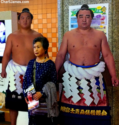 Woman poses with Somu wrestlers in Tokyo, Japan