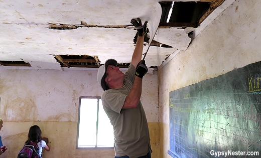 Taking down the ceiling in our classroom in Africa with Discover Corps