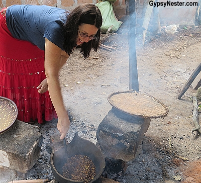 Veronica learns how to roast coffee beans over an open fire in Tanzania with Discover Corps