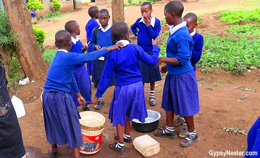 Children carry heavy buckets of water to their classrooms and the school vegetable garden every day. There is no running water at their school
