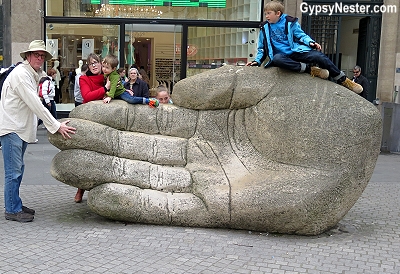 David and some kids posing on the severed hand of Antwerp, Belgium - GypsyNester.com
