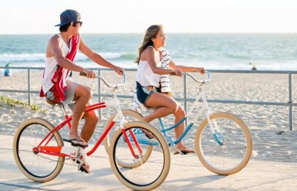 riding a bike on the beach