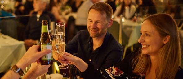 Couple raising a toast aboard the Sydney Showboat dinner cruise
